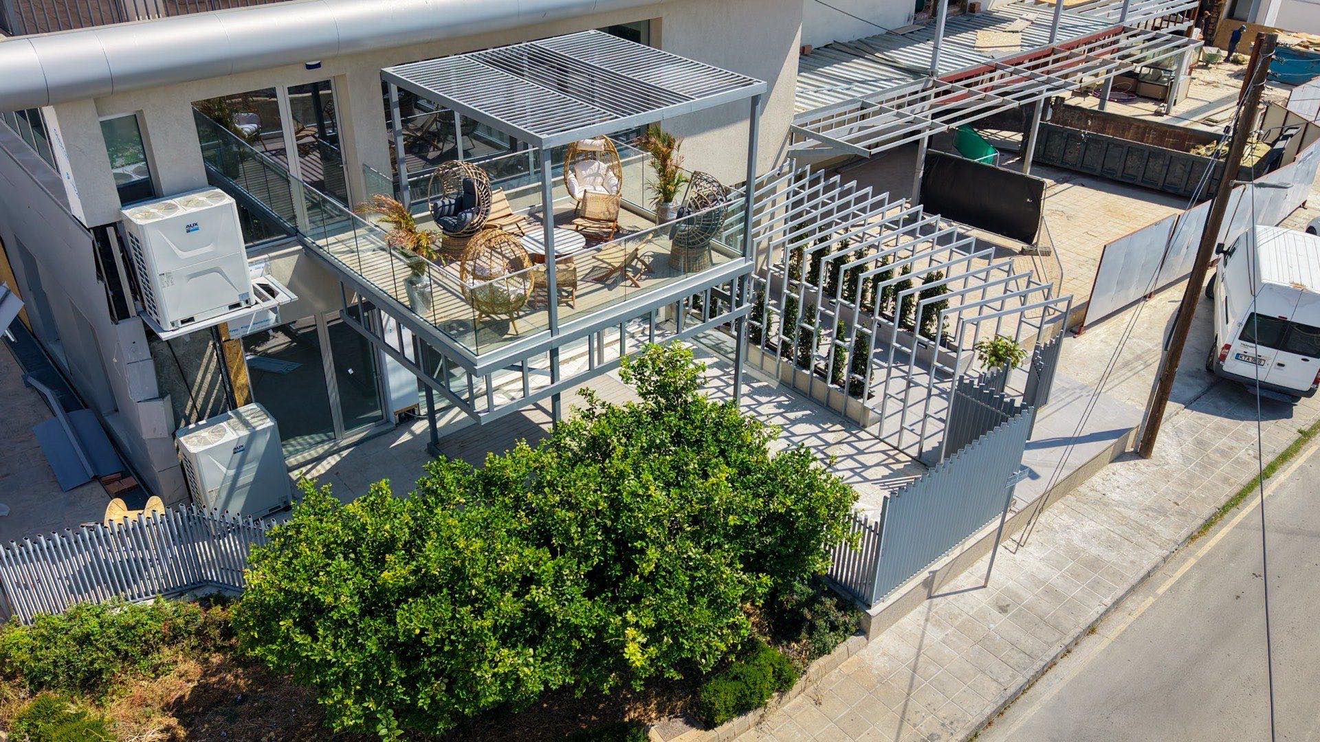 Drone photograph of a modern commercial property and its terrace in Cyprus